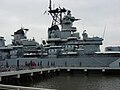 The midships section of the USS New Jersey from shore.