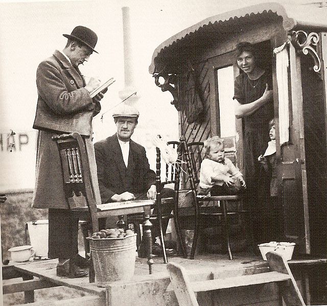 A census taker visits a family of indigenous Dutch Travellers living in a caravan in the Netherlands in 1925