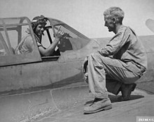 A P-40 pilot of the squadron holds up a finger to tell his crew chief that he has downed a German plane, Paestum airfield, 15 September 1943 59th Fighter Squadron P-40 pilot Lt Bernie Byrne and crew chief Paestum September 1943.jpg