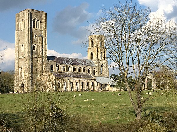 Wymondham Abbey from the south, view across River Tiffey and Abbey Meadow