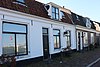 Helft van dubbel woonhuis, voormalig winkelwoonhuis