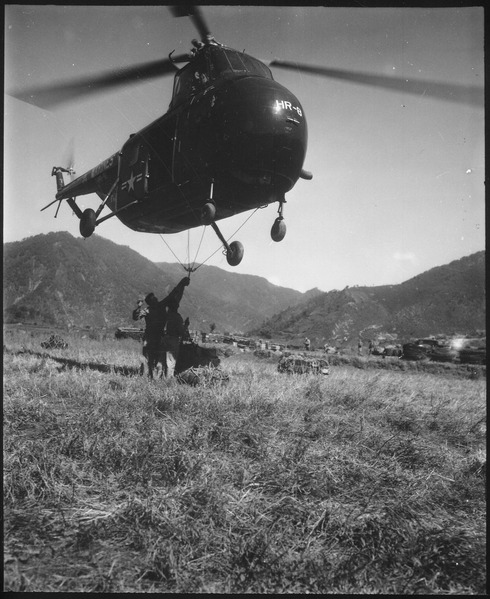 File:An HRS-1 Sikorsky helicopter hovers close to the ground while Marines hook a cargo net loaded with 1,000 pounds of... - NARA - 532420.tif