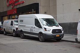 2015-2018 Transit mid-roof cargo van (in front of Ford E-350).
