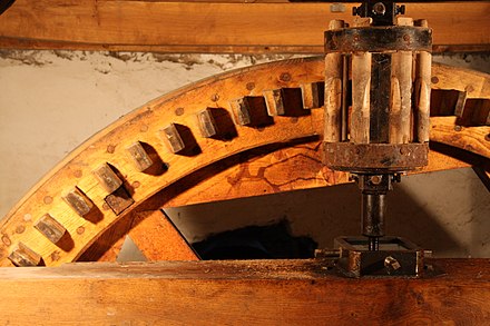 Wooden cogwheel driving a lantern pinion or cage gear
