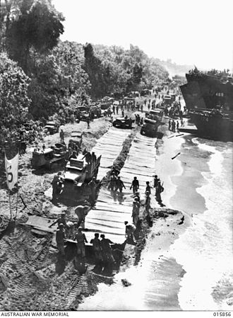The US 532nd Engineer Boat and Shore Regiment lays beach mats to allow vehicles to move along the sand at Red Beach, near Lae Engineers at Red Beach.JPG