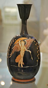 A lekythos bottle in the Gnathia style depicting the winged goddess of victory, Nike, armed and dancing, Apulia (Magna Graecia), Italy Gnathia style lekythos Antikensammlung Kiel B 707.jpg