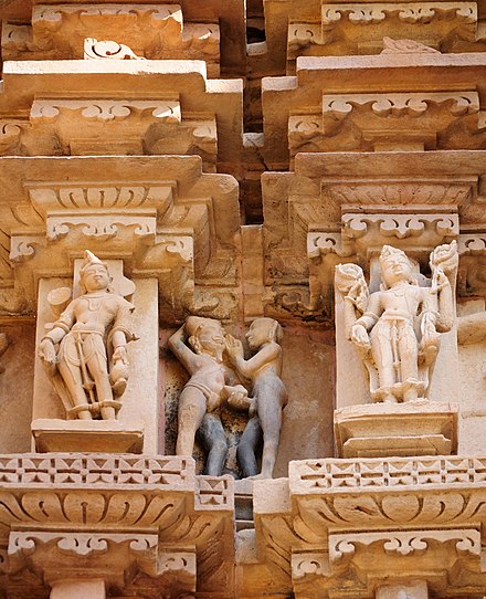Erotic sculptures of two men (centre) at the Khajuraho temples