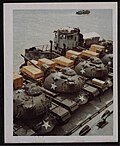 Thumbnail for File:M48 tanks of the 11th Armored Cavalry Regiment on a barge after being offloaded from SS American Robin.jpg