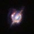 Merging galaxies in the distant Universe through a gravitational magnifying glass (15045195572).jpg