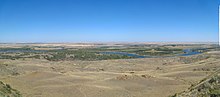 The Missouri River, as it forms the southern border of the Fort Peck Indian Reservation. The Assiniboine (Nakota) and Sioux (Dakota) tribes were among the first to sign a water rights compact with the state of Montana. Missouri River below Fort Peck Dam.jpg