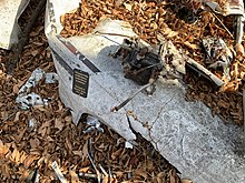 The plaque dedicated to Burton B. Burks in the wreckage of the plane.