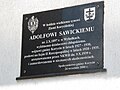 Polski: Tabliczka pamiątkowa Adolfowi Sawickiemu przy wejściu do budynku urzedu gminy w Korycinie, gmina Korycin, podlaskie English: Memorial plaque dedicated to Adolf Sawicki by an entrance to the gmina's office building in Korycin, gmina Korycin, podlaskie, Poland