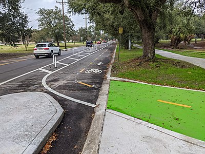 A protected bike lane in New Orleans, USA. This bike lane uses physical barriers to enforce separation. Note that weak barriers such as this may still fail to stop negligent motorists from illegally entering the bike lane.