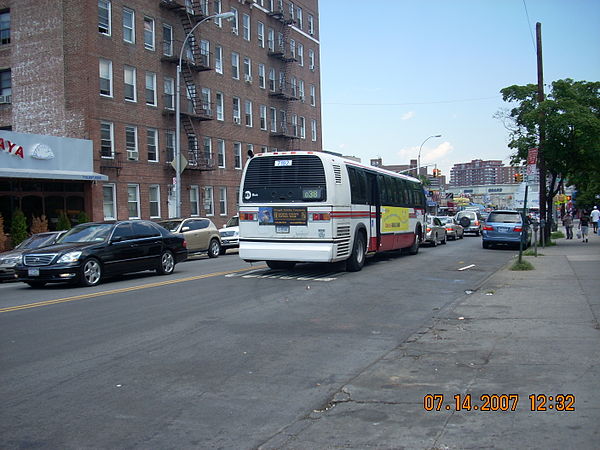 Rear view of an MTA Bus Company bus on the Q38 route in Rego Park, with Triboro Coach colors.