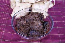 Authentic Minangkabau rendang is dark in colour, served with ketupat Rendang daging sapi asli Padang.JPG