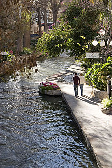 A couple strolls along the Riverwalk by Las Canarias restaurant, at the Omni La Mansion Hotel. Riverwalk20.jpg