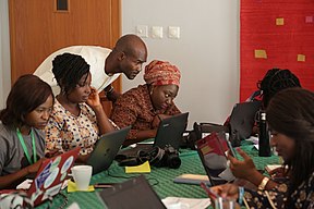 Runcie Chidebe, Curator, Wikimedia Abuja Hub guiding some ladies on how to create Wikimedia articles.jpg