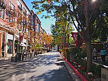 Tree-lined commercial streets characterize the district. Santana Row (2).jpg