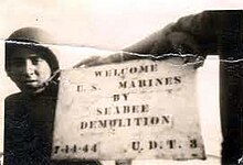 Seabees in both UDT 3 and 4 made signs to greet the Marines assaulting Guam. However, Team 4 was able to leave theirs on the beach for the Marines to see that the Seabees had been there first. UDT 4 posted this sign again on the Hotel Marquee for its 25-year reunion. Seabee Demolition UDT 3.jpg