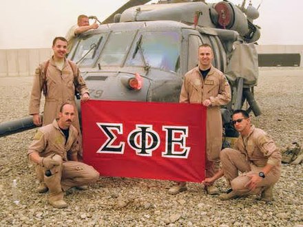 U.S. Air Force, Airmen, presumably members of Sigma Phi Epsilon, display that fraternity's flag in Iraq in 2009.
