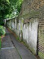 Churchyard wall outside St George in the East in the eponymous area.