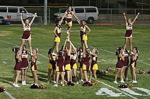 Barstow High Aztec cheerleaders at a football game. Stunt 1.jpg