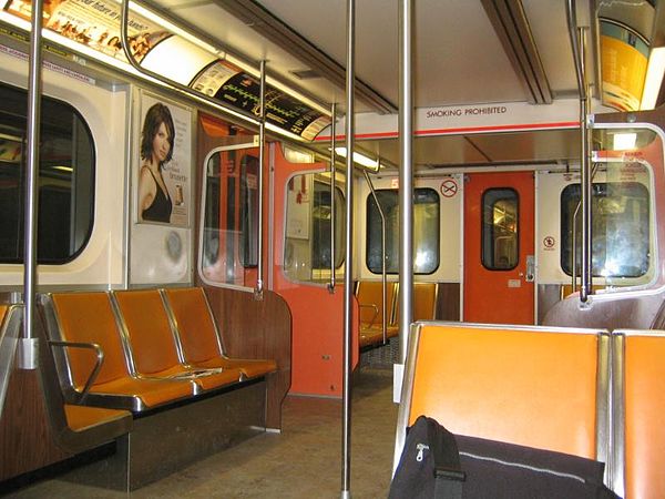 Interior of an H-6 subway car with individual vinyl orange covered seats.