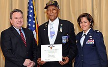 Congressman Christopher Smith presented the Purple Heart Medal to Tuskegee Airman Tech. Sgt. (Ret.) George Watson Sr. with then Col. Gina M. Grosso, Joint Base McGuire-Dix-Lakehurst commander Tuskegee Airman Tech. Sgt. (Ret.) George Watson Sr. is presented the Purple Heart medal by Congressman Christopher Smith and Col. Gina M. Grosso, Joint Base McGuire-Dix-Lakehurst commander.jpg