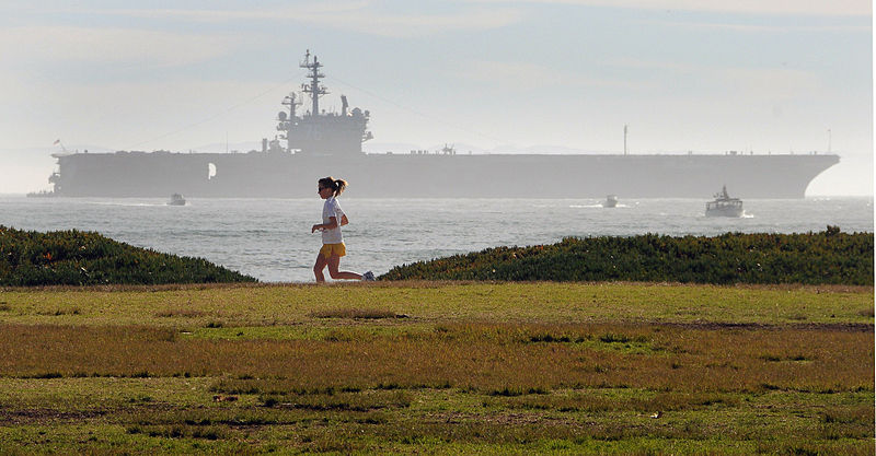 File:US Navy 080112-N-1722M-005 A jogger uses the bike path along Cabrillo Blvd. as the Nimitz-class nuclear-powered aircraft carrier USS Ronald Reagan (CVN 76), sits anchored offshore.jpg