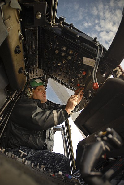 File:US Navy 100114-N-8590G-002 Aviation Electricians Mate 1st Class Ihosvani A. Diaz, assigned to Helicopter Anti-Submarine Squadron Light (HSL) 46, performs maintenance as naval air crewmen conduct preflight inspections.jpg