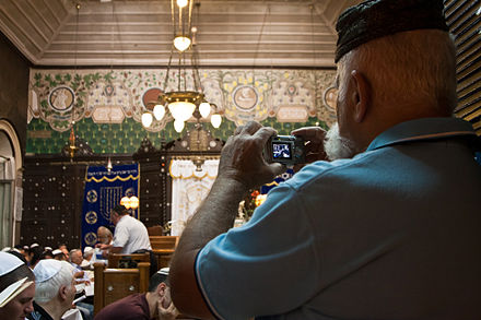 Syrian Jews worship in Ades Synagogue.  Renowned as a center for Syrian Hazzanut (Syrian Jewish liturgical singing), Ades is one of only two synagogues in the world that maintains the ancient Syrian Jewish tradition of Baqashot, the marathon Kabbalistic singing held in the early hours of Shabbat morning to welcome the sunrise over winter months.