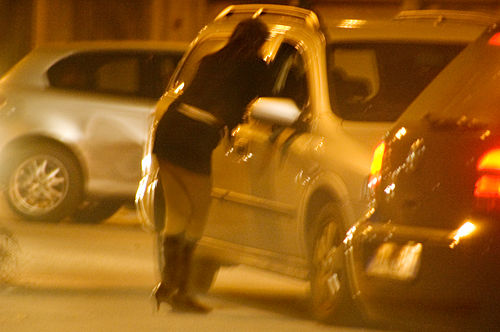 A street prostitute talking to a potential customer in Turin, Italy, 2005