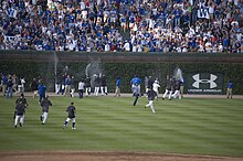 The Cubs and fans celebrate the 2008 National League Central Division championship. A few Cubs Win flags are visible. 20080920 Chicago Cubs and fans celebrate the 2008 regular season division championship.jpg