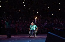 Wheelchair basketball captain and coach at the Opening Ceremony of the Sydney Paralympics in 2000. 201000 - Opening Ceremony paralympian Kevin Coombs torch - 3b - 2000 Sydney opening ceremony photo.jpg