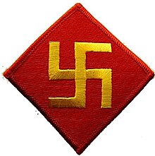 A red diamond with a yellow swastika inside it