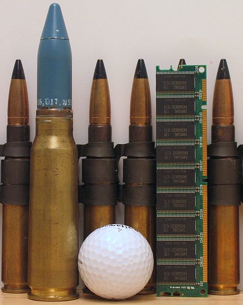 A 20×102 mm round (second from left) with .50 BMG rounds, golf ball, and a stick of 168-pin SDRAM computer memory