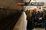 Passengers wait for the next arriving train at the Fifth Avenue/53rd Street station in December 2012