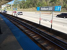 Addison sign, platform edge, freeway (38512747916).jpg