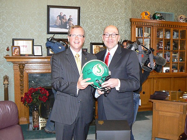 Wall discusses Canadian football with US ambassador David Jacobson.