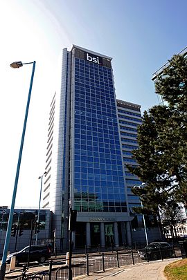 BSI Group headquarters building in Gunnersbury, West London, featuring the BSI Group logo BSI logo on BSI headquarters building 2016.JPG