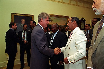 Conyers shaking hands with President Bill Clinton in 1993