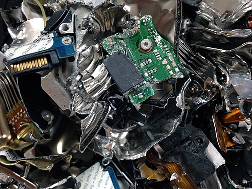 The pieces of a physically destroyed hard disk drive.