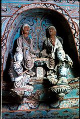 Sculptures in a niche above a main Buddha figure, Mogao cave 27, High Tang