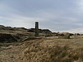 A view of the chimney, ruined buildings and spoil heaps of Musbury heights.