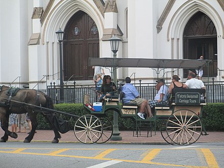 A carriage from Historic Carriage Tours of Savannah pauses at the Cathedral of St. John the Baptist.