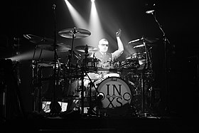 Farriss performing with INXS in 2012 INXS (7562188286).jpg