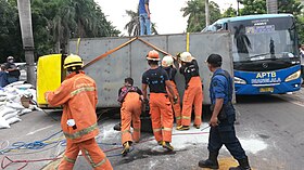 Indonesian fire fighters handling a traffic accident in Jakarta Indonesian fire fighters during a traffic accident.jpg