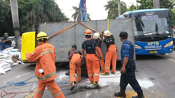 Indonesian fire fighters handling a traffic accident in Jakarta
