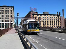 An MBTA route 7 bus - the descendant of the streetcar route run in 1916 - on the bridge in 2017 MBTA route 7 bus on Summer Street bridge, June 2017.JPG