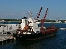 The superstructure of this cargo ship is in the back and includes a lifeboat. MV Ascension in Port Canaveral.jpg